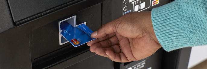 Hand inserting MasterCard atm card