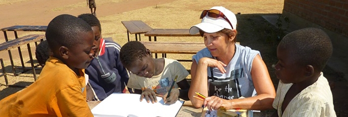 Woman tutoring young boys